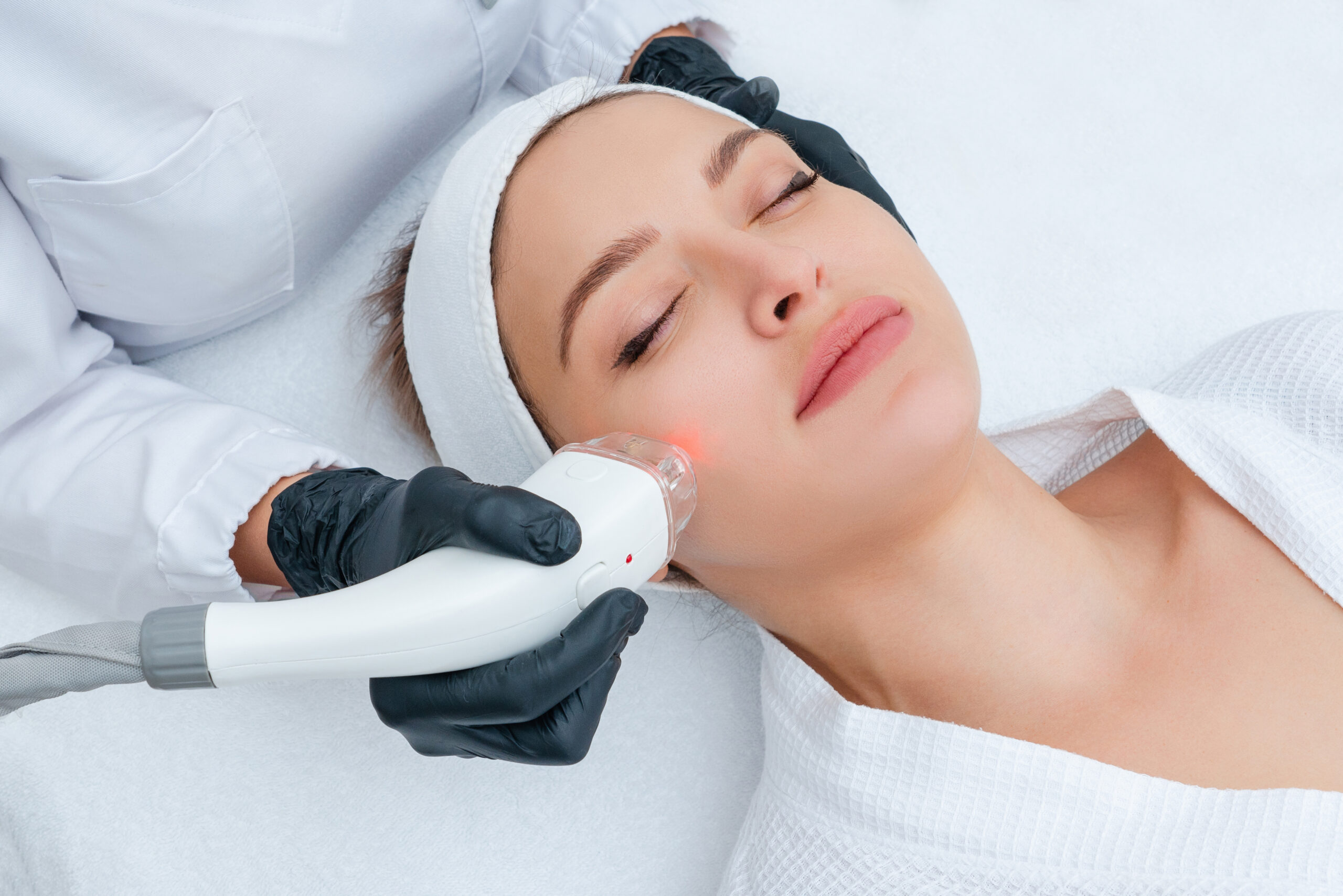 Woman receiving laser treatment on her face